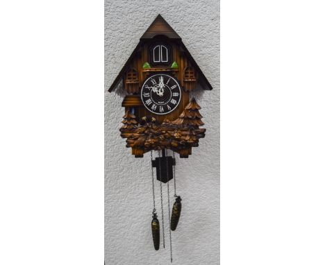 A Kaiser Quartz Modern Two Weight Cuckoo Clock with a water wheel.