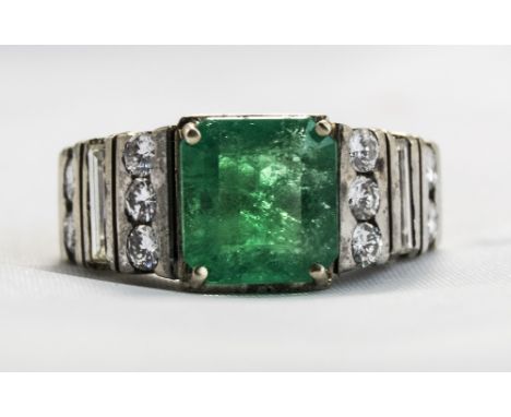 18ct White Gold Set Emerald And Diamond Ring. The Single Step Cut Emerald of Good Colour with Diamond Set Shoulders. Emerald 