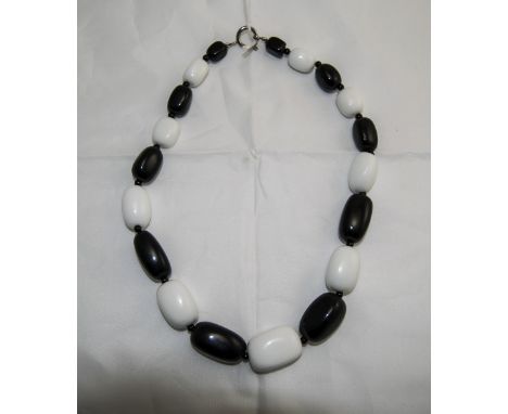 Monochrome Agate Large Stone Necklace comprising alternate, graduated, whlte and black agate, cuboid stones, fastened with a 