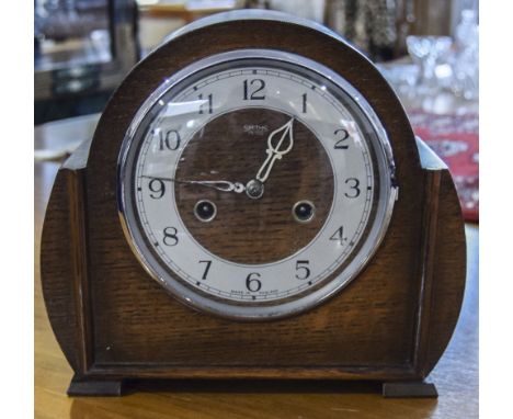 Oak Cased Mantle Clock, Height 9 inches, Width 9.75 inches.
