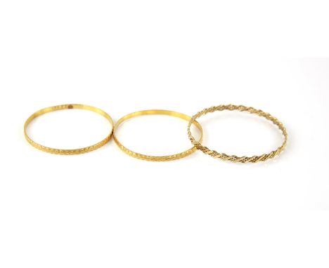 Two matching round gold faceted bangles, testing as 22 ct, internal diameter 5.9cm, and a 9 ct gold woven bangle, internal di