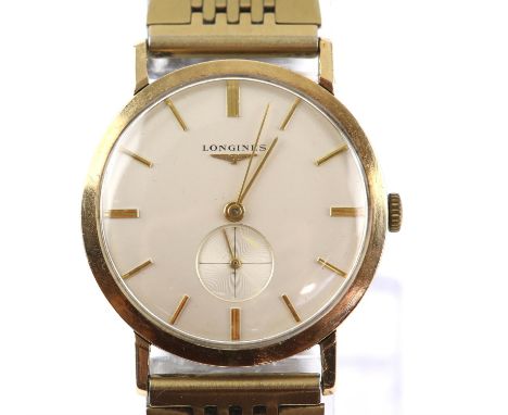 a Longines  A Gentleman's gold wristwatch, the signed dial with baton hour markers and subsidiary seconds dial, fitted with a