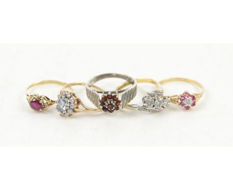 Collection of five gem set rings including a three stone diamond twist ring stamped 18 ct and platinum, ring size N, a ruby a