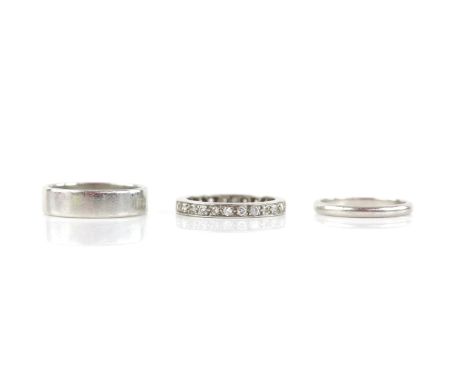 Three rings, including a full eternity ring, set with round brilliant cut diamonds, weighing an estimated 1.15 carats, size N