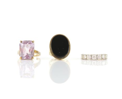 Three rings including, a rectangular cut amethyst ring in hallmarked 9 ct gold, size P, a large signet ring set with a large 