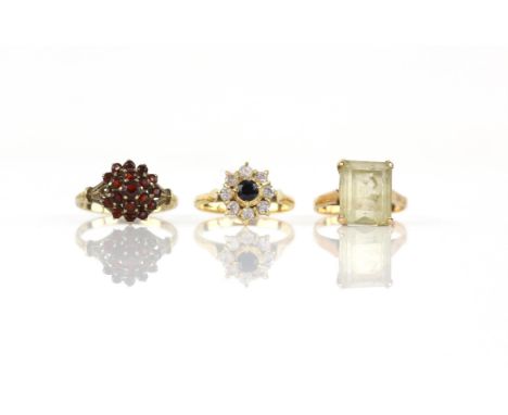 Three gem set vintage rings, including a single stone citrine ring, size K 1/2, a garnet cluster ring, size M, both in 9 ct a