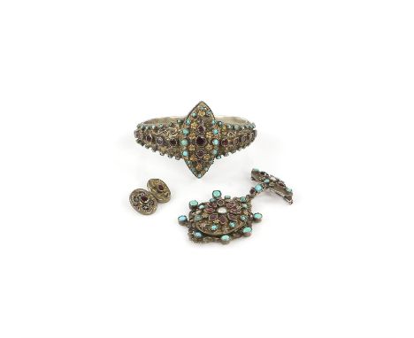 Austro-Hungarian hinged silver gilt bangle, set with turquoise and garnets, with a central marquise shaped panel, with a simi