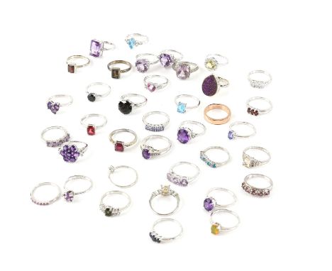 A collection of thirty-seven rings, including oval cut amethyst ring with paste set shoulders, a square cut synthetic ruby si