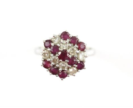 Vintage ruby and diamond cluster ring, set with eight round brilliant cut diamonds, estimated total diamond weight 0.56 carat