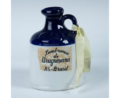 Charming ceramic liquor jug finished with cobalt blue glaze over clear glazed ceramic. Dimensions: 6.75"H x 5" dia. Condition