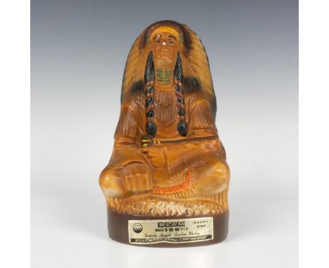 A striking decanter featuring a seated Native American chief holding a pipe, adorned with vibrant green, red, and yellow acce