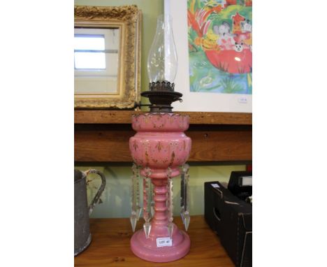 A LATE VICTORIAN PINK GLASS LUSTRE MOUNTED OIL LAMP 36.5cm high (to the top of the pink crown) 
