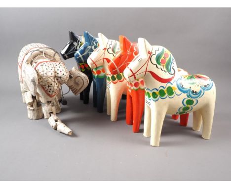 Five Swedish painted wood model horses and a carved and painted wood heffalump string puppet