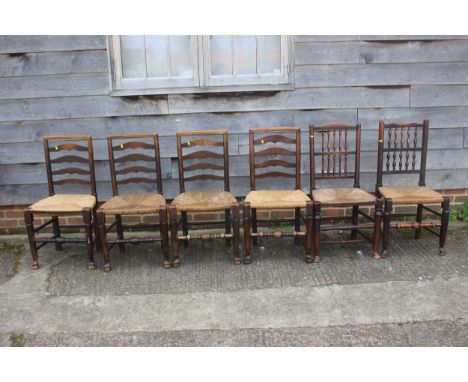 A set of four oak ladder back dining chairs with rush seats, and a similar matched pair of spindle back rush seated dining ch