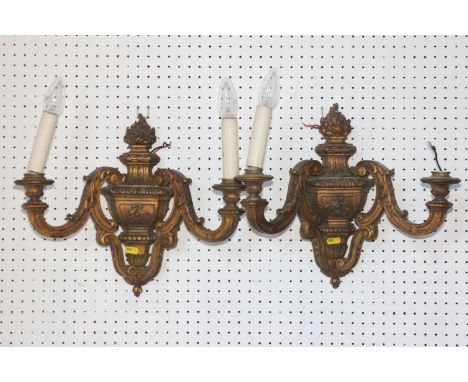 A pair of carved giltwood two-light wall brackets of early 18th century design with flambeau finials, 14" high&nbsp;(ex Fawle