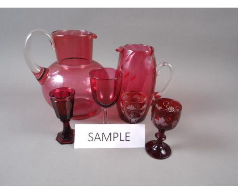 A 19th century faceted ruby glass liqueur, 4" high, four cranberry glass jugs, tallest 7 1/2" high, and other cranberry and r
