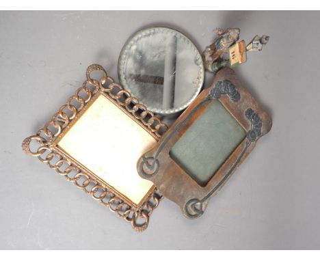 A painted metal desk calendar, figure by a lamp, 6" high, a copper openwork photo frame and an embossed metal mounted photo f