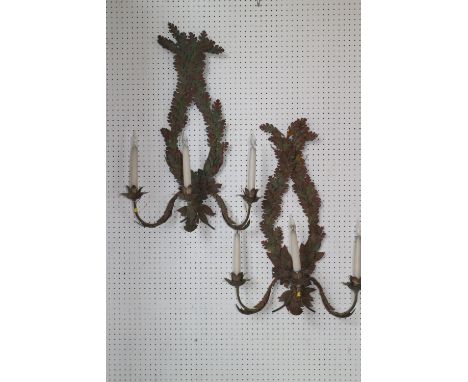 A pair of painted stamped metal, oak and laurel leaf three-light wall brackets, 28" high (ex Fawley Court) 
