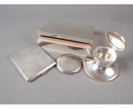 A silver cigarette box, a silver capstan inkwell, an engine turned silver cigarette case and a similar powder compact 