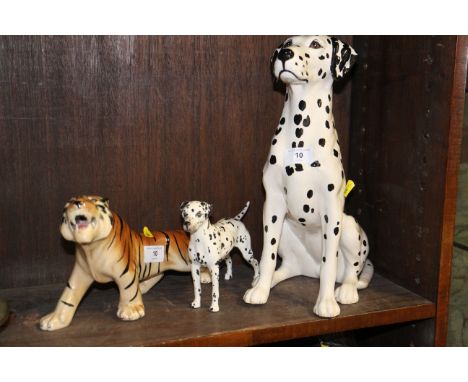 A Beswick seated Dalmatian, 14" high, a Beswick standing dog, 8" long and a model tiger, 11" longCondition:The tiger is craze