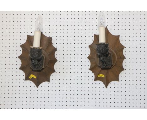 A pair of single light black japanned wall lights, on shape wood back plate, 13" high (ex Fawley Court) 