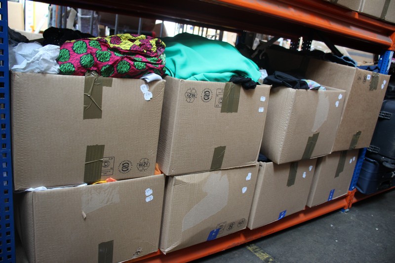 Eight boxes of assorted clothing and related items.