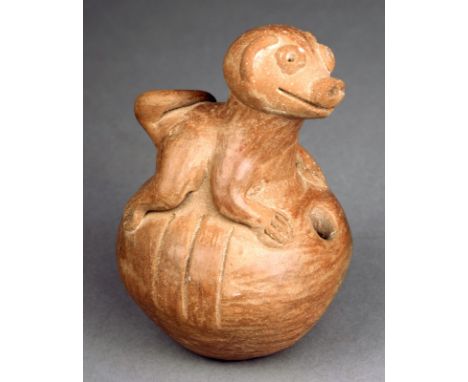 A Pipil vessel El Salvador ceramic, of ovoid form with a hole to the front and with a recumbent dog, 12cm high.