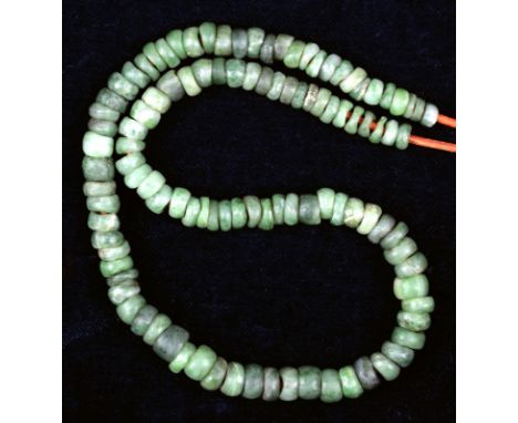 A Kanak necklace New Caledonia nephrite, of one hundred and seven beads, re-strung, 42.5cm long. cf. De jade at de nacre, Pat