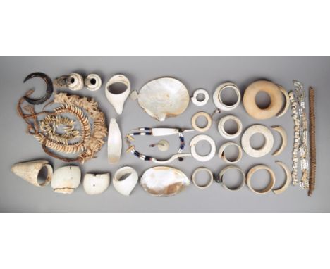 A small collection of shell ornaments Naga and Oceanic including armbands, one with pricked decoration and hung with beads, a