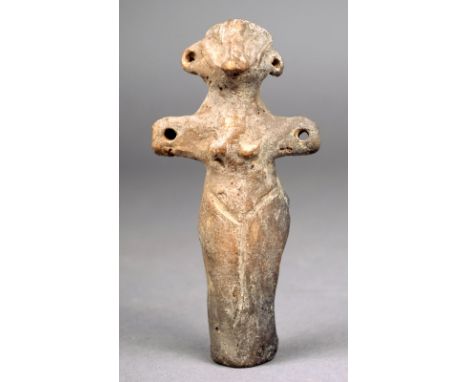 A Neolithic Vinca female idol 5000 - 4000 BC ceramic with pierced ears and arms and with incised linear decoration, 11cm high