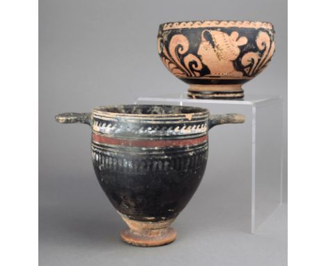 An Apulian kylix circa 4th century BC handles missing and painted two female heads, scrolls and palmettes, 7.5cm high, and an