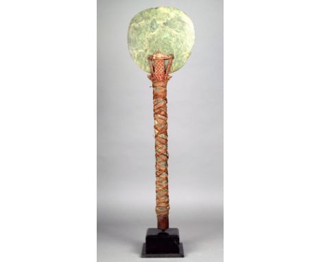 A Kanak ceremonial axe New Caledonia nephrite, wood and fibre, with a circular blade pierced and bound to the cylindrical sha