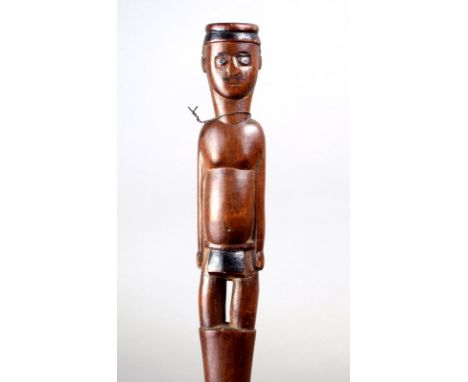 A Tsonga staff South Africa wood with a standing male figure wearing a head ring and a lion cloth, with burnished decoration,