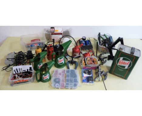 A graduated set of contemporary Castrol green oil jugs, three hub pullers and various tools.