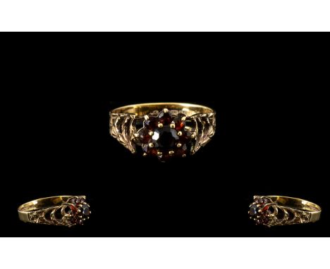 9ct Gold Garnet Set Cluster Ring With open worked shoulders. Fully hallmarked for 9ct gold, ring size O, good condition in al