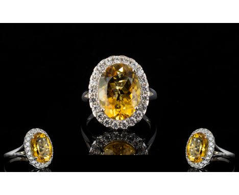 Citrine Statement Halo Ring, an oval cut golden yellow citrine of 8.5cts, framed by a row of round cut, natural, white zircon