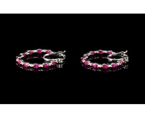 Ruby Hoop Earrings, a pair of fine hoops set with marquise cut rubies to both the front and inside back curves of the circles