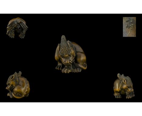 Japanese Late 19thC Carved Boxwood Netsuke in the form of a Mythical Japanese Creature. Signed to underside. 1.75 inches 4.40