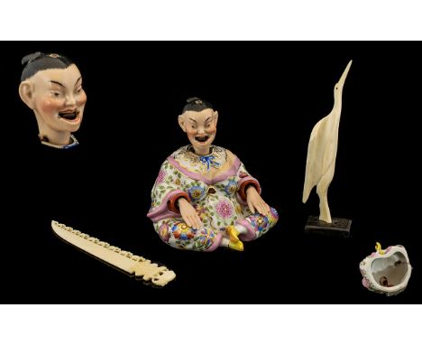 A Continental Glazed Ceramic Nodding figure In The Form Of Seated Oriental Female head and hands articulated, the whole paint