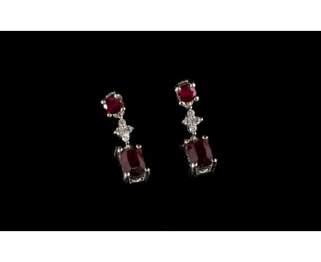 Ruby and Cambodian Zircon Drop Earrings, each earring having a cushion cut ruby, of over 1ct, set below a quatrefoil  with wh