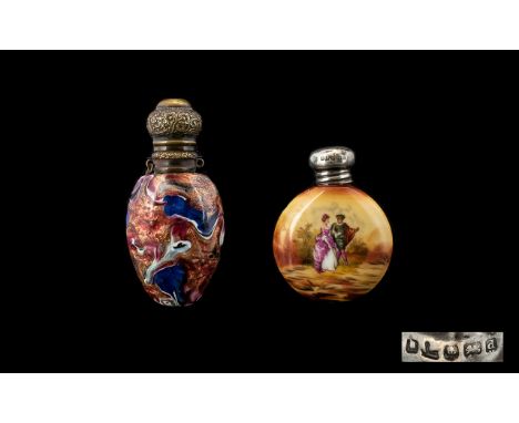 Two Antique Silver Topped Scent Bottles The first of circular flask form in ceramic with painted courting couple decoration, 