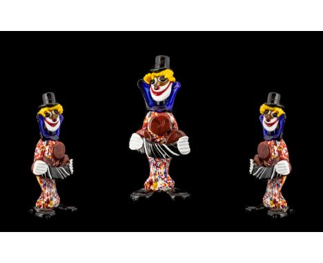A Murano Glass Figure In The Form Of A Whimsical Clown Blown glass figure modelled with black top hat, confetti glass tunic w