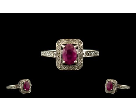 Ladies 9ct White Gold Ruby and Diamond Set Dress Ring, The Central Faceted Ruby of Good Colour, Surrounded by 26 Small Diamon