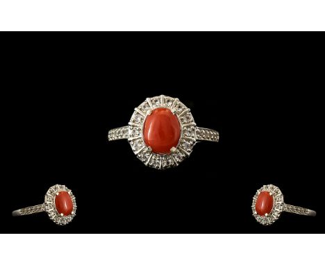 Natural Coral and White Topaz Halo Ring, an oval cut cabochon of natural coral from the Mediterranean, framed with a 'halo' o