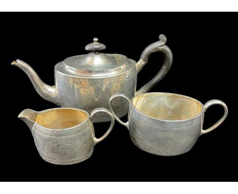 VICTORIAN SILVER MATCHED THREE PIECE TEASET comprising teapot, sucrier and jug, oval shape, engraved with initials within wre