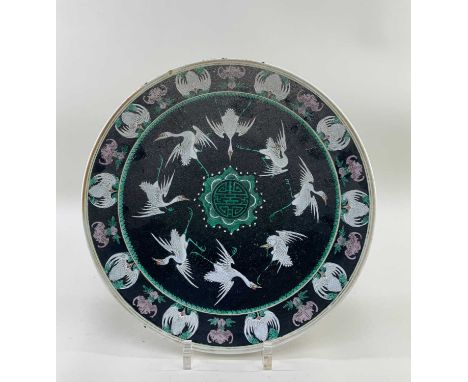 CHINESE FAMILLE NOIR 'CRANE & BAT' DISH, 6-character Qianlong mark, decorated with eight Manchurian cranes around a central S