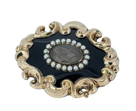 VICTORIAN YELLOW METAL & ENAMEL MOURNING BROOCH, c. 1850, rococo outer frame with oval glass enclosing interwoven hair within