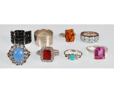 A stamped 925 silver ladies dress rings to include a pink stone ring, a blue stone cabochon ring with a halo of blue stones s