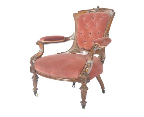 A high Victorian 19th century mahogany salon / drawing room armchair. Raised on reeded and fluted turned legs with castors ha