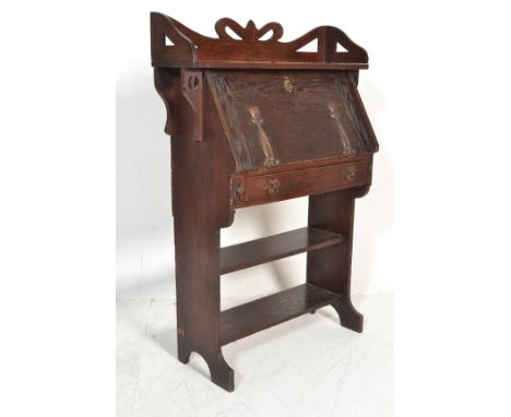 A Victorian 19th century Arts &amp; Crafts solid oak student bureau desk in the manner of Liberty &amp; Co. Shaped sides with